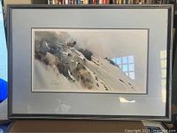 Framed limited edition print showing elk on misty mountain side with artist signature and numbering visible.