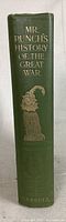 Spine view of the green hardcover book showing title 'Mr. Punch’s History of the Great War' and gold decorative artwork including Mr. Punch illustration.