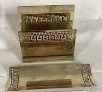 Brass desk set including pen caddy and letter holder with Greek key cutouts shown from above.