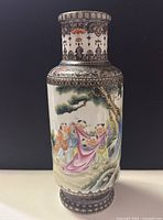 Front view showing polychrome figural scene of attendants draping silk under a pine tree on glossy white ground.