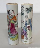 Front view of two Chinese porcelain hand-painted bud vases side by side, highlighting figures and decorative details.