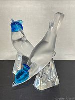 Two crystal bird figurines on display showing overall lot