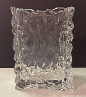 Front view of clear crystal vase with crinkled paper bag design showing faceted texture and 7 inch height