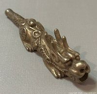 Front left side angle of the silverplated dragon pipe showing detailed dragon head and body patterns.