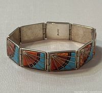 Angled view of bracelet closed displaying hinge links