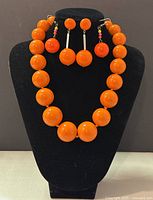 Set of Liz Claiborne necklace and two pairs of earrings displayed on a black jewelry stand.