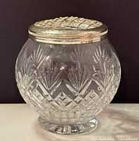 Front view showing the cut crystal pattern and silver top with grid for arranging flowers.