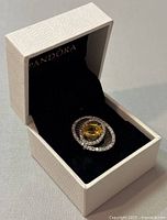 Ring displayed in a Pandora branded white box on black velvet insert showing the ring's overall design and presentation.