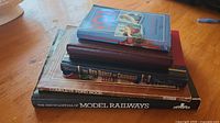 Stack of books showing spines and covers including The Encyclopedia of Model Railways and others