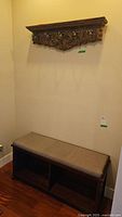Wall mounted coat rack above bench showing complete setup with cushion and storage.