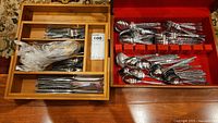Wide shot showing wooden cutlery tray with stainless steel cutlery and red lined box with Levco cutlery.