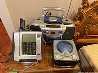 Overview of all items on a wooden table with part of a wooden bed frame visible