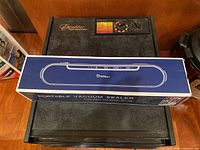 Black Excalibur food dehydrator with box of Fifilion vacuum sealer on top
