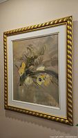 Framed original abstract floral painting hanging on the wall showcasing muted tones with yellow and white flowers.