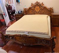 Full view of bed frame with headboard, footboard, and mattress