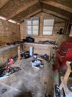 Interior overview showing toolbox, string trimmer, shelf with clamps and leaf blower