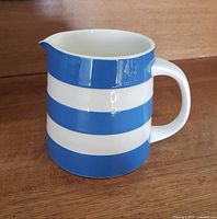 Photo of Cornishware jug showing front angle against wooden background