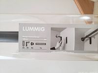 Label on the Ikea Lummig curtain pole packaging showing item specifications and installation illustrations.