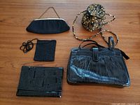 Overview photo showing all five handbags on a wooden surface