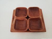 Rectangular serving tray with four square condiment dishes placed inside