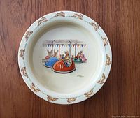 Top-down view of the ceramic bowl showing the detailed Bunnykins 'Bumper Cars' illustration and bunny border.
