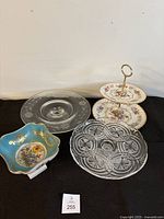Four cake stands shown: two-tiered floral Avon stand, etched glass round stand, pressed glass round stand, small turquoise dish