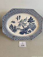 Front view of the hexagonal Blue Willow plate showing overall design and shape.