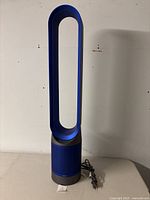 Front view of bladeless tower air purifier fan on table.