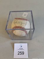 Rawlings official baseball signed by Pat Hentgen inside a clear acrylic display case, viewed from various angles.