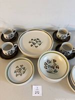 Full set arranged showing all dishware types with cups on saucers, stacked plates and bowls.