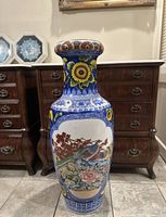 Full front view of the porcelain floor vase on tile floor