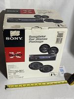 Box front showing Sony branding and XPlod car stereo package with visual of speakers and receiver.
