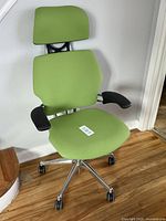 Front left angle view of the chair showing full profile, upholstery and armrests