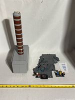 Full assembled Thor's hammer with base and minifigures including Thor, viewed from front and side