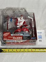 Front view of packaged Dominik Hasek action figure with accessories in rare white jersey variant.