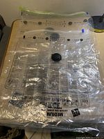 Clear plastic vacuum storage bag, large size, showing valve and printed instructions.
