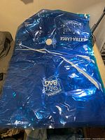 Four blue transparent extra large vacuum seal bags stacked together showing their size and vacuum valve.