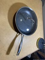 Top-down view showing the frying pan with speckled non-stick surface and metal handle.