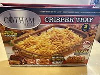 Front of box showing Gotham Steel Crisper Tray with fries image, features including non-stick titanium copper and ceramic, oven safe up to 500°F, dishwasher safe, PTFE/PFOA/PFOS free
