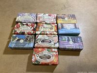 Top view showing ten boxed soap bars by Nesti Dante with floral and Tuscan landscape themed packaging.