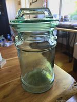 Photo of the LE Smith glass milk can shaped canister with lid closed, showing the green-tinted thick glass and sturdy handle on the lid.