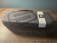 Photo showing the exterior of the closed Nintendo Switch case on a wooden surface.