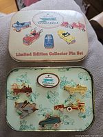Collector tin closed with Kiddie Car Classics and Limited Edition Collector Pin Set text, showing lid artwork of kiddie cars in red, blue, and yellow.