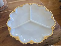Top view of the vintage Anchor Hocking milk glass divided dish showing white opaque glass with gold trim and three separate compartments.