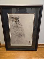 Framed print of a great horned owl in grayscale, double matted with black outer mat, beige inner mat and black frame with subtle beading.