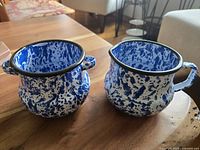 Side view showing the shape, handles, and blue splatter pattern