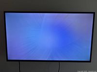 Front view of the Samsung TV displaying a blue screen, no visible damage on screen surface.
