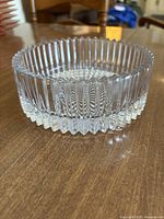 Front angled view showing ribbed vertical pattern on the sides and scalloped edge.