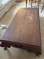 Top view of rectangular wooden coffee table showing wood grain and wear marks