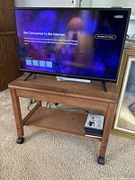 Vizio 32-inch Smart TV displayed on wooden stand showing 'Not Connected to the Internet' screen.